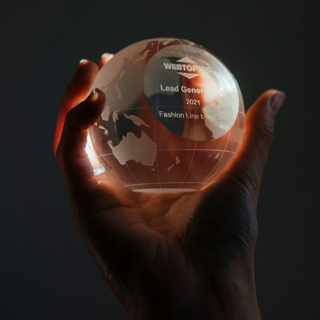 a man holding a globe, global impact award
