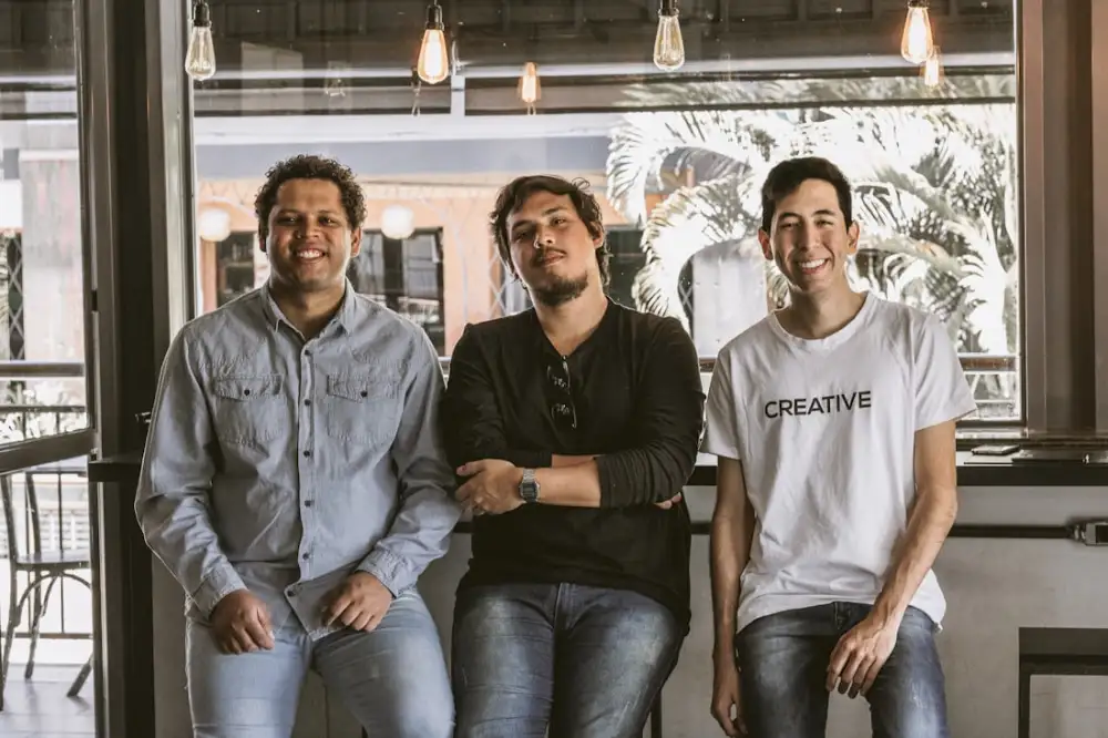 Three startup founders smiling together